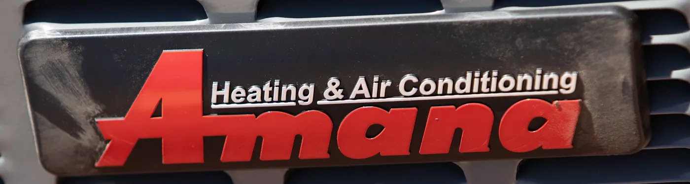 Amana heating and air conditioning brand plate on a condenser installed by Paragon
