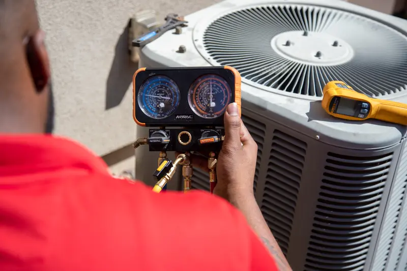 Paragon technician checking refrigerant pressures on an AC condenser