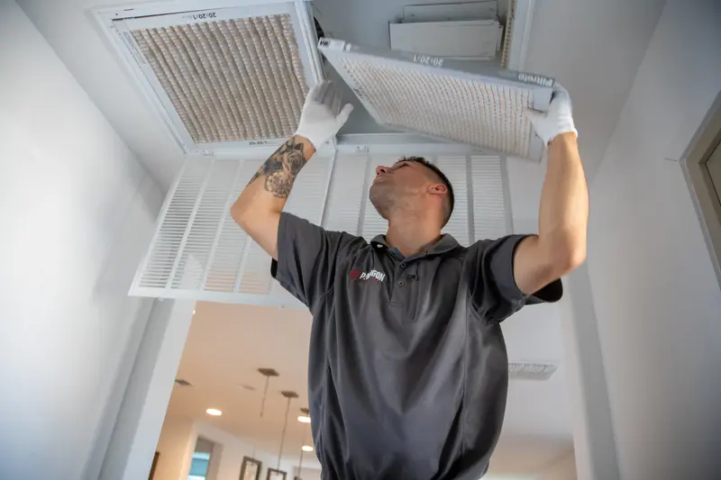 Paragon technician replacing a home air filter