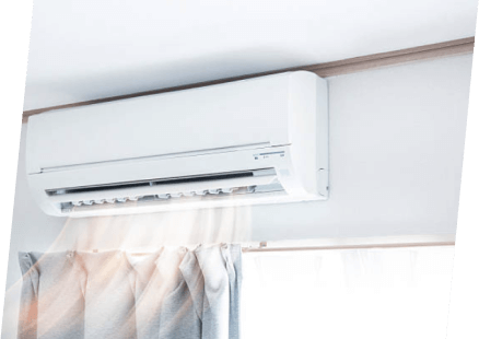 A white air conditioner partially covered by a curtain, showcasing a clean and modern interior by Paragon Service Pros.