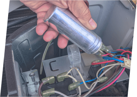 A technician from Paragon Service Pros repairs a water heater using a screwdriver, demonstrating skilled maintenance work.