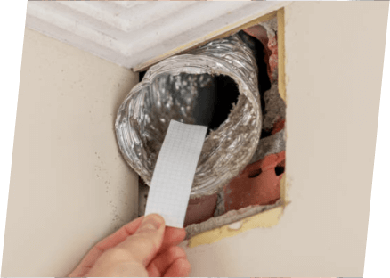 A person affixes a piece of paper to the wall, representing the services of Paragon Service Pros.