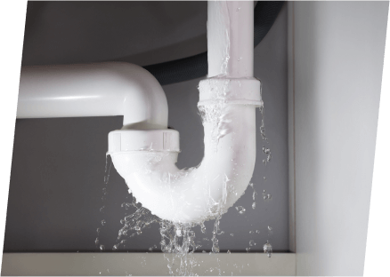 A white pipe discharging water, showcasing the plumbing services of Paragon Service Pros.
