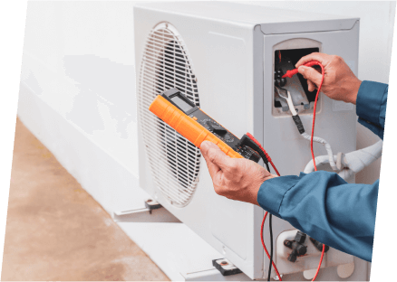 A technician from Paragon Service Pros repairs an air conditioner using specialized tools for efficient service.