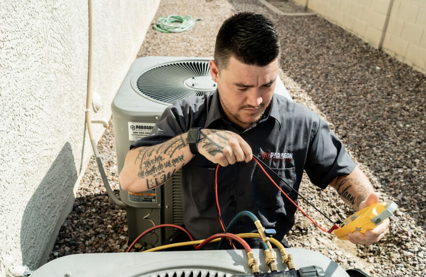 Professional AC repair specialist using tools to adjust and service an outdoor air conditioning unit, improving system functionality and airflow.